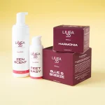 Collezione di prodotti Re9va di Linea55 con flaconi di Zen Scent e Feet Easy accanto alle confezioni bordeaux di Harmonia e Blue B Breeze su sfondo giallo.